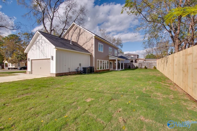 view of property exterior with cooling unit, a garage, and a yard