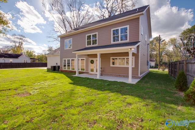 rear view of house with a yard, a patio, and central AC unit