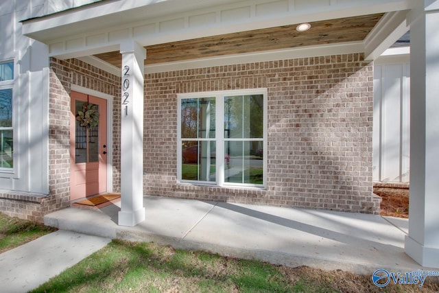 view of exterior entry with a porch