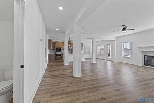 197 Chesire Cove Ln, New Market, AL 35761 - unfurnished living room featuring wood-type flooring, ceiling fan, and a high end fireplace