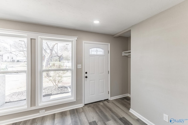 entryway with wood finished floors and baseboards