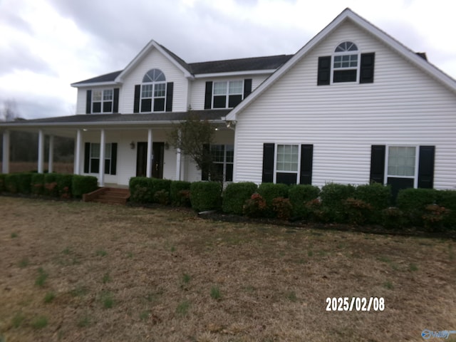 view of front of house featuring a front yard and covered porch