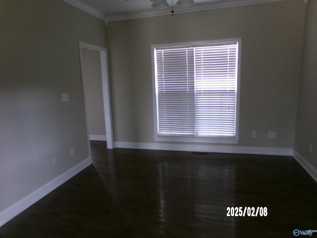 empty room featuring ornamental molding and dark hardwood / wood-style floors