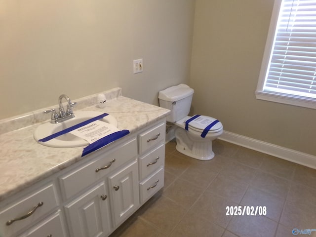 bathroom featuring tile patterned flooring, vanity, and toilet