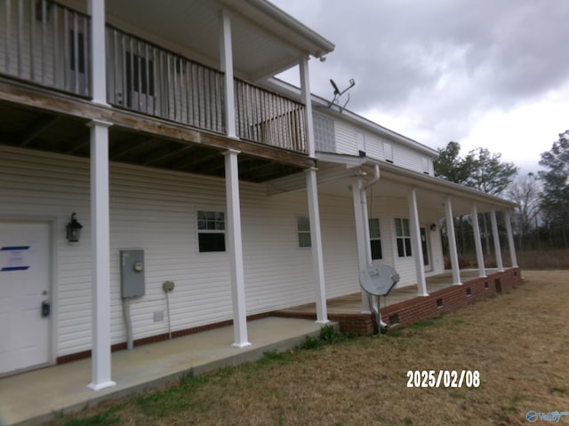 view of side of home featuring covered porch