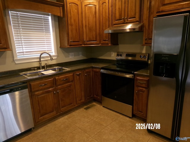 kitchen featuring stainless steel appliances, light tile patterned flooring, and sink