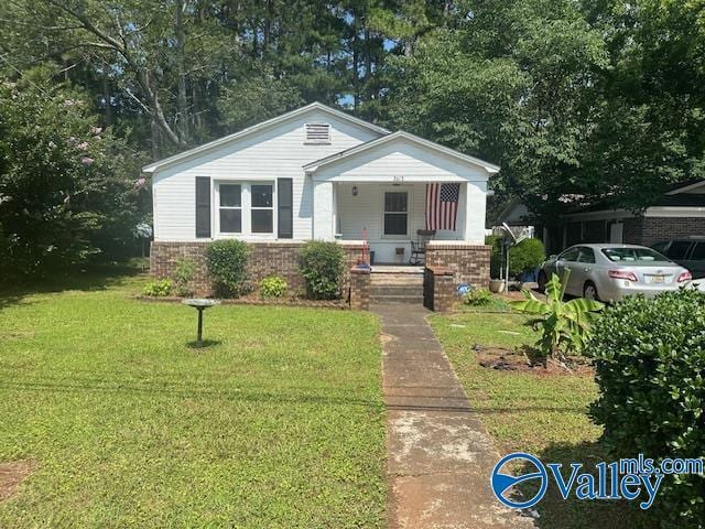 3613 Mcvay St, Huntsville, AL 35805 - bungalow-style house with covered porch, a front yard, and brick siding