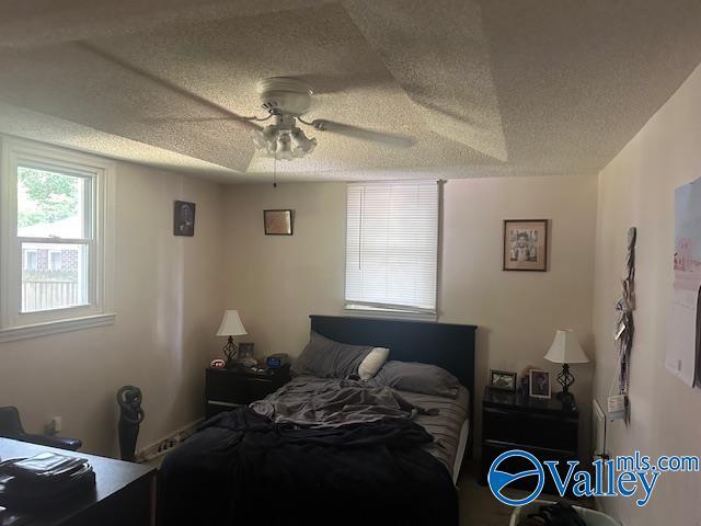 3613 Mcvay St, Huntsville, AL 35805 - bedroom featuring a textured ceiling and a ceiling fan