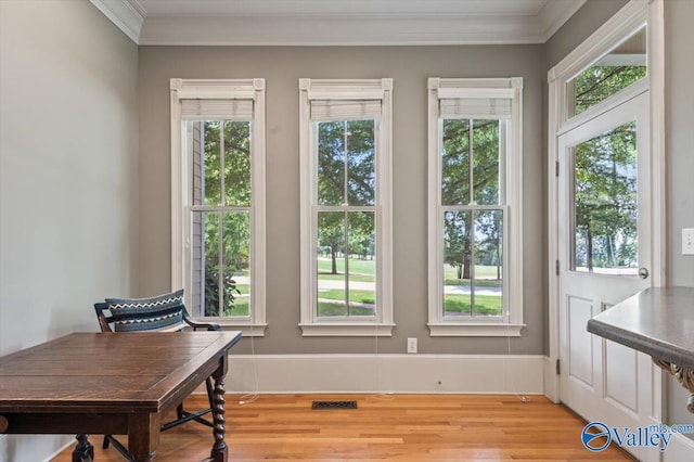 entryway with light wood-type flooring, visible vents, and ornamental molding