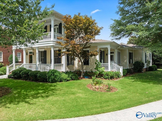 greek revival inspired property featuring a porch, a balcony, and a front yard