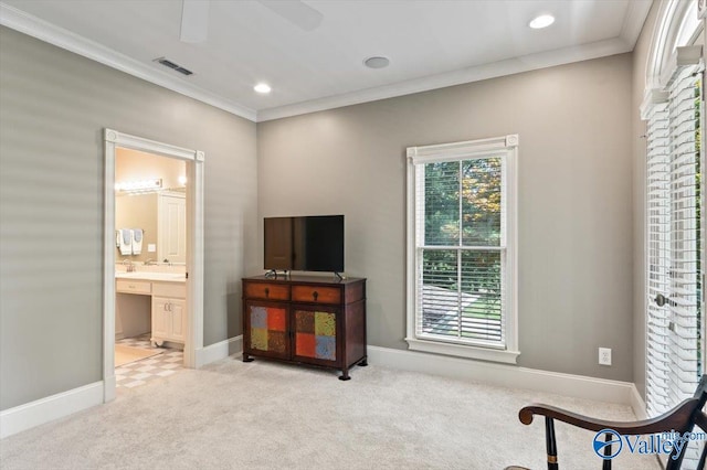 sitting room with carpet, visible vents, crown molding, baseboards, and ceiling fan