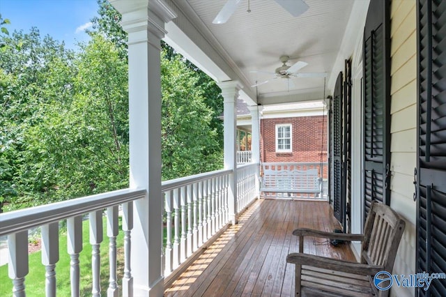 wooden terrace featuring a ceiling fan