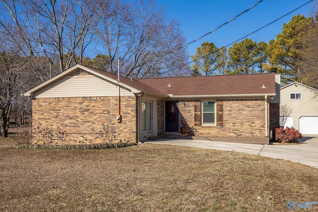 single story home featuring entry steps, a chimney, a front lawn, and brick siding