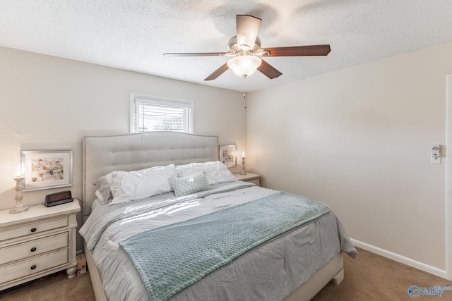 bedroom featuring carpet, a textured ceiling, and baseboards