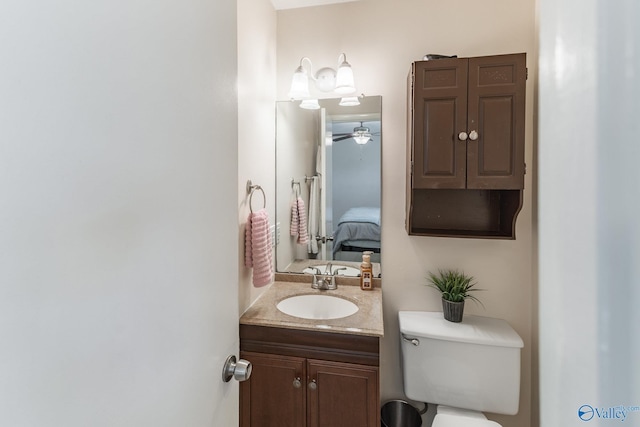 bathroom featuring connected bathroom, vanity, and toilet