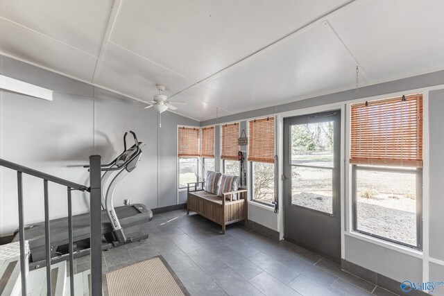 exercise area with a sunroom, baseboards, vaulted ceiling, and a ceiling fan