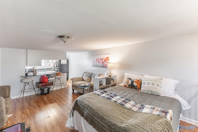 bedroom with baseboards and wood finished floors