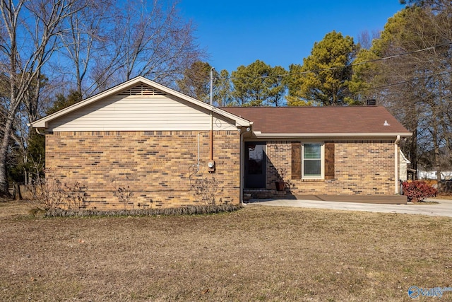 ranch-style home with brick siding and a front lawn