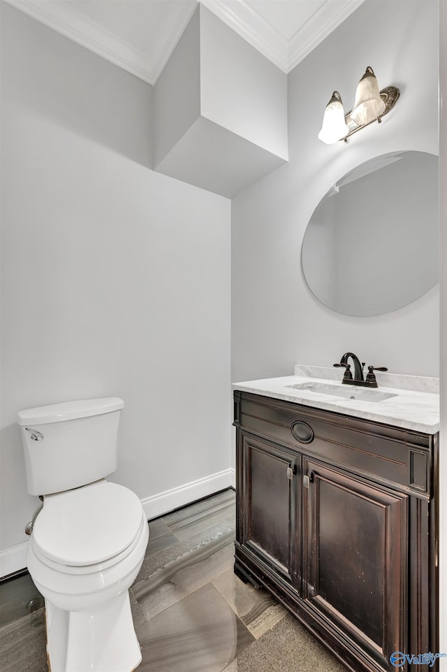 bathroom with toilet, vanity, crown molding, and hardwood / wood-style floors