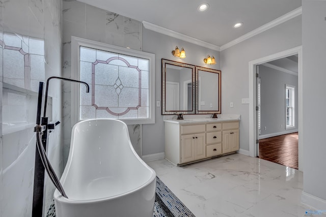 bathroom with crown molding, a bathtub, and vanity