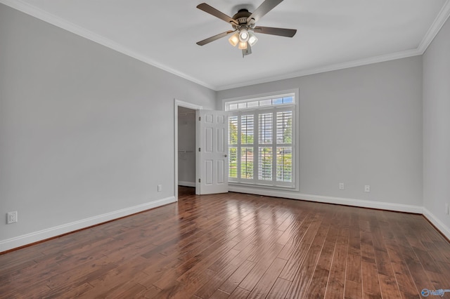 empty room featuring ceiling fan, dark wood-type flooring, and crown molding