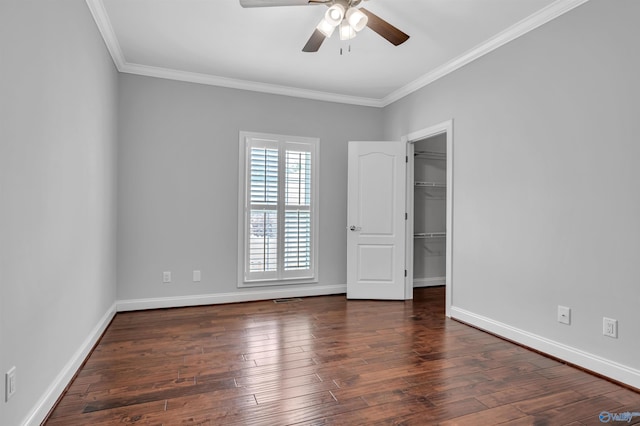 spare room with ceiling fan, dark hardwood / wood-style floors, and crown molding