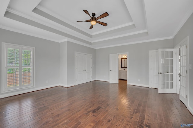 unfurnished room featuring ceiling fan, dark hardwood / wood-style flooring, crown molding, and a raised ceiling