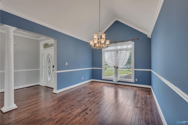 spare room with lofted ceiling, dark hardwood / wood-style flooring, crown molding, and decorative columns