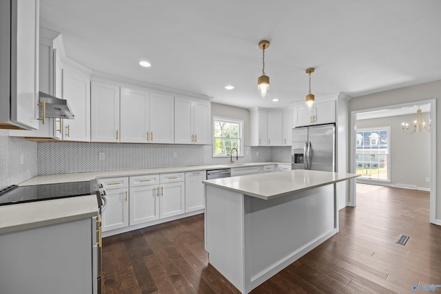 kitchen featuring white cabinets, a sink, extractor fan, light countertops, and appliances with stainless steel finishes