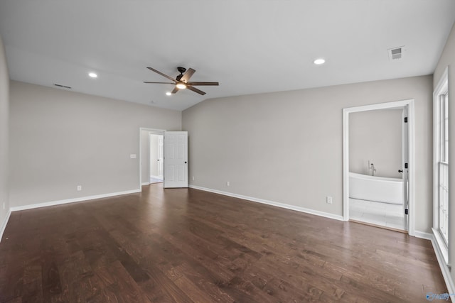 spare room featuring baseboards, visible vents, ceiling fan, and dark wood-style flooring