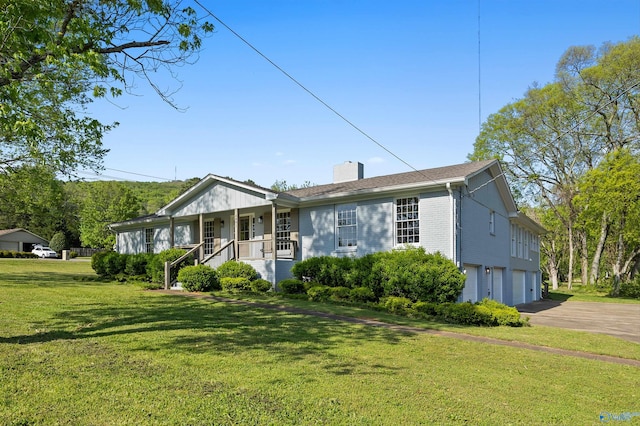 ranch-style house with a chimney, a front lawn, driveway, a porch, and a garage