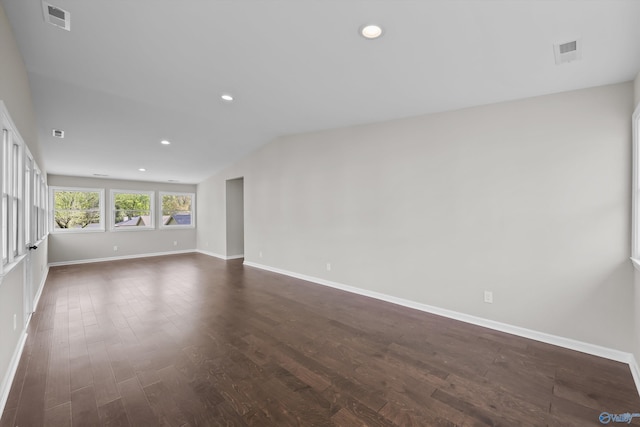 unfurnished room with lofted ceiling, baseboards, visible vents, and recessed lighting