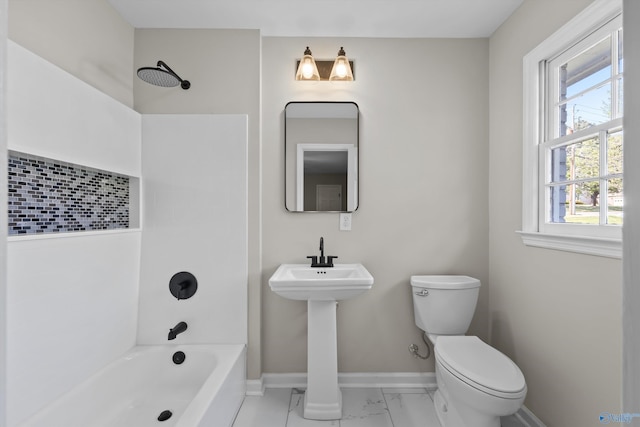 full bath featuring toilet, a sink, marble finish floor, baseboards, and shower / bathtub combination