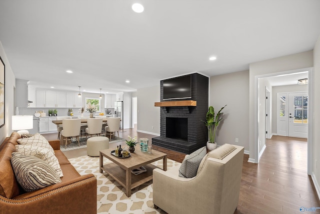 living room featuring recessed lighting, a healthy amount of sunlight, and light wood finished floors