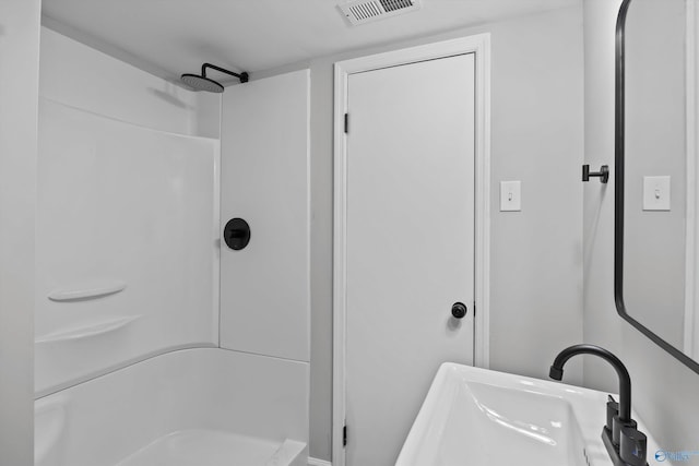 full bathroom with walk in shower, visible vents, and a sink