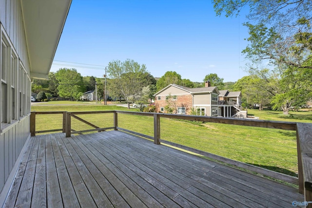 wooden deck featuring a yard