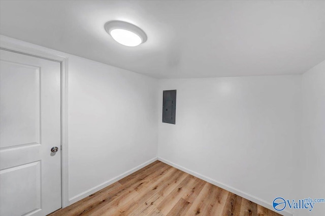 bonus room featuring electric panel and wood-type flooring