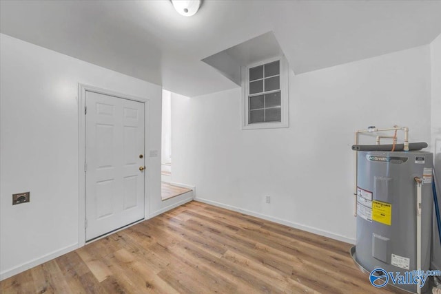 interior space with water heater and hardwood / wood-style floors