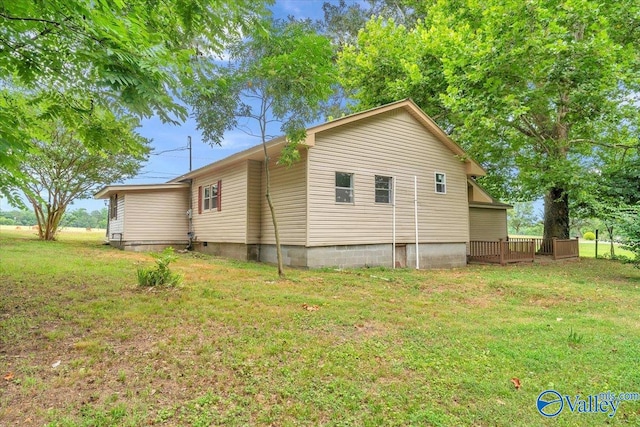 view of side of property with a lawn