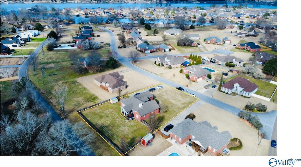 birds eye view of property with a water view and a residential view