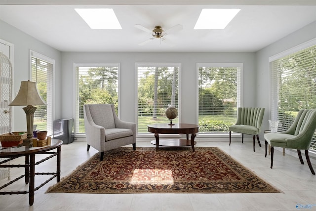 sunroom featuring a wealth of natural light and a skylight