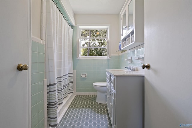 bathroom featuring vanity, tile walls, curtained shower, and toilet