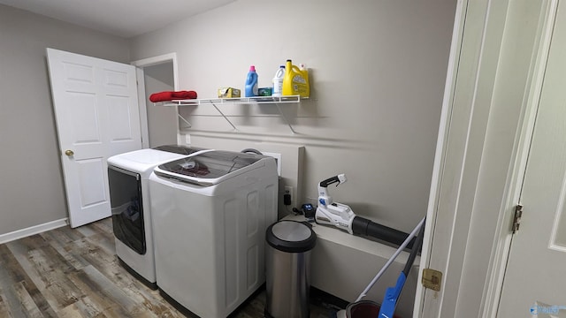 laundry area featuring separate washer and dryer and wood-type flooring