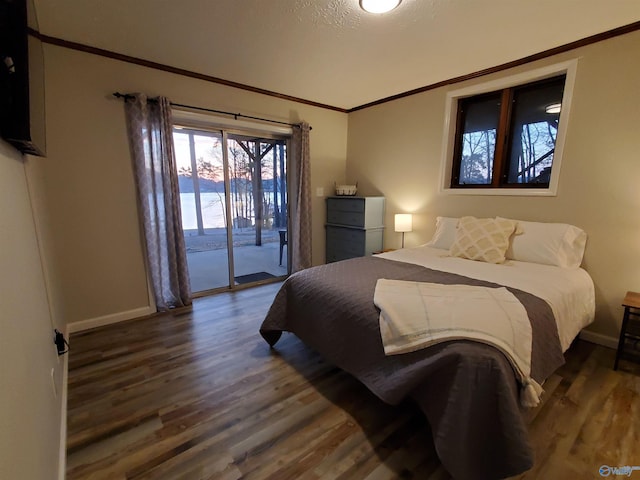 bedroom with a textured ceiling, access to exterior, and dark hardwood / wood-style flooring