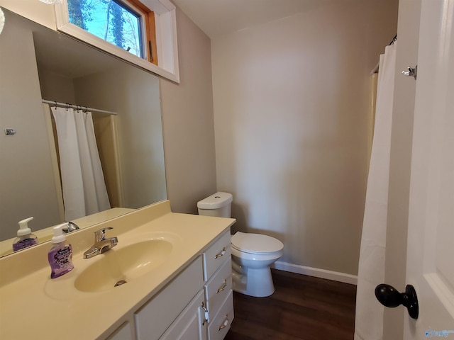 bathroom featuring vanity, hardwood / wood-style floors, and toilet