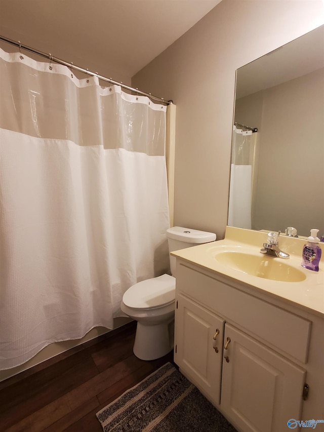 bathroom with hardwood / wood-style flooring, vanity, and toilet