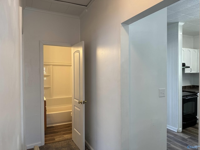 corridor with crown molding and dark hardwood / wood-style floors