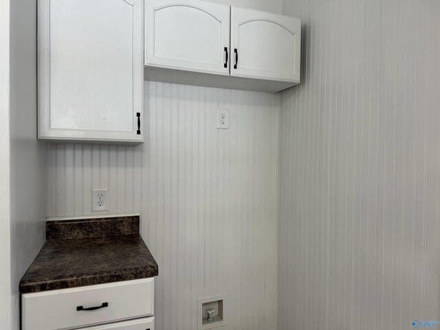 interior space featuring washer hookup and cabinets