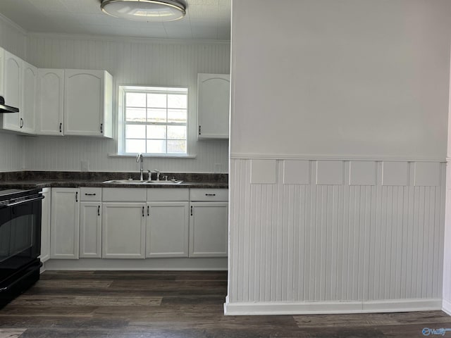 kitchen featuring black electric range oven, crown molding, sink, white cabinets, and dark hardwood / wood-style flooring