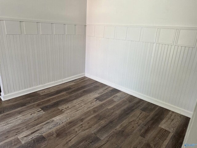 unfurnished room with wood-type flooring